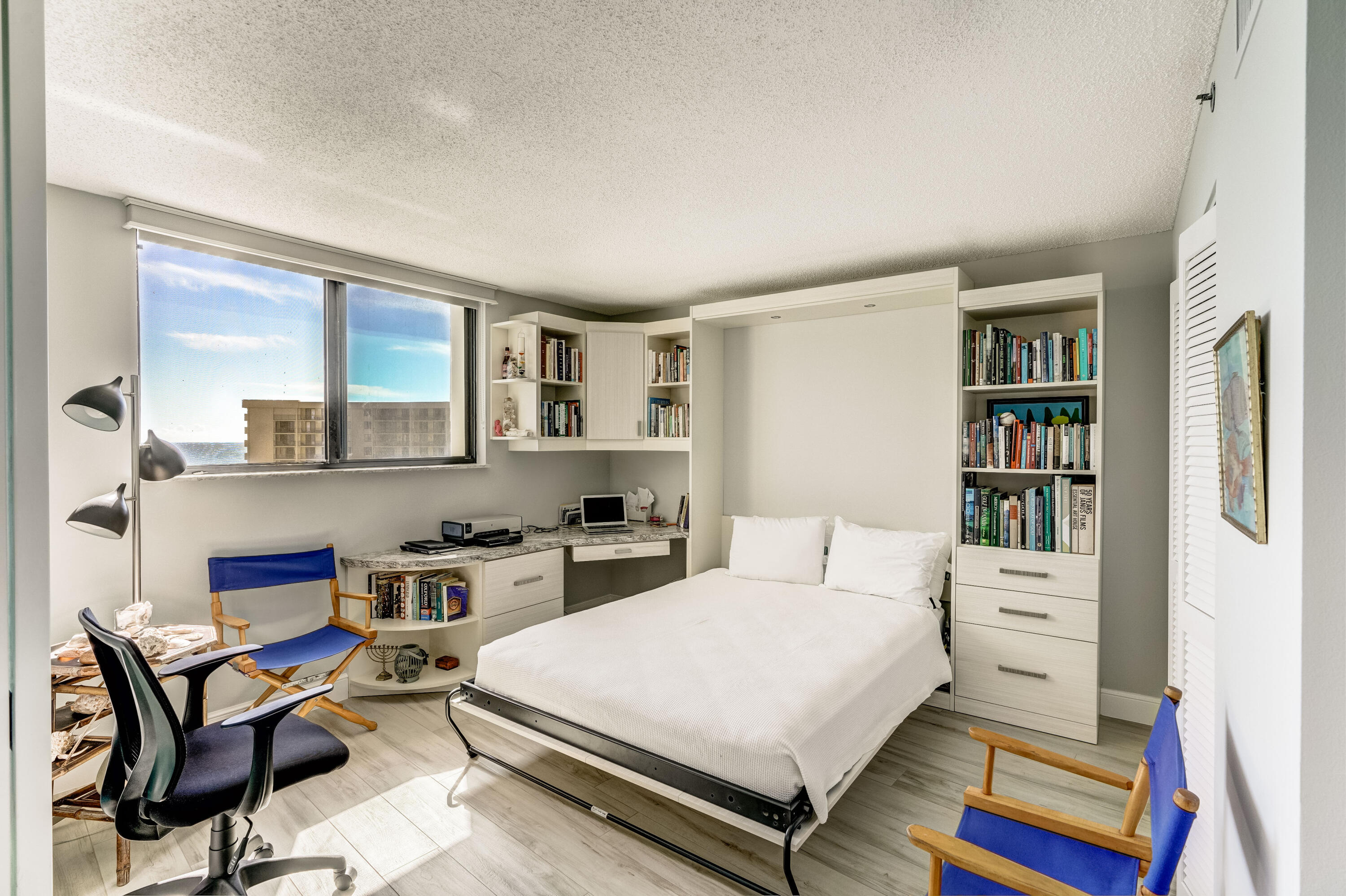 200 Ocean Trail Way, Unit 1107 Jupiter, FL 33477 - Photo 18 of 29 a bedroom with a bed a table and chair