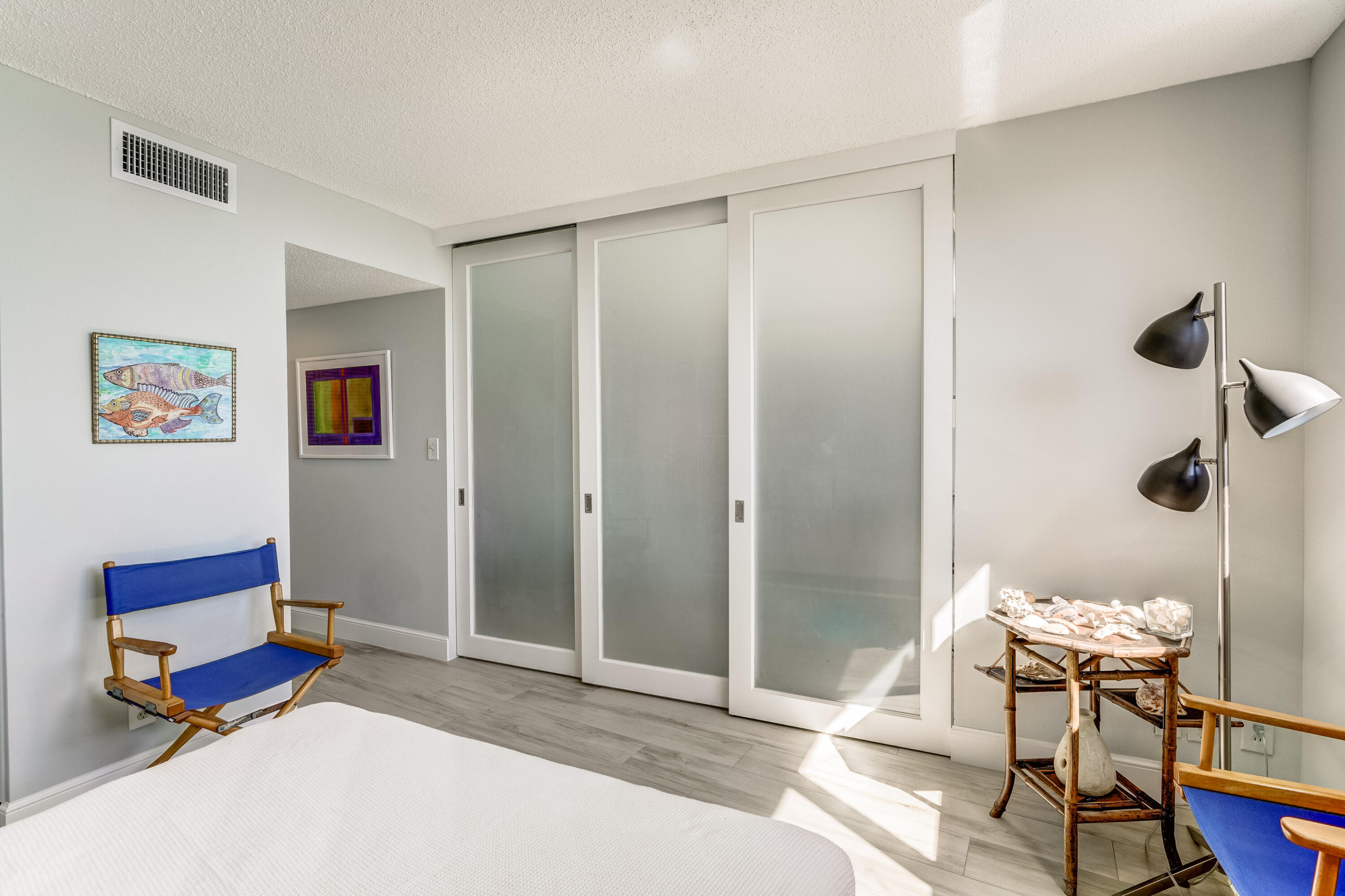 200 Ocean Trail Way, Unit 1107 Jupiter, FL 33477 - Photo 19 of 29 a spacious bedroom with a bed and a table in it