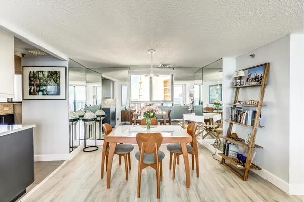 a view of a dining room with furniture and wooden floor
