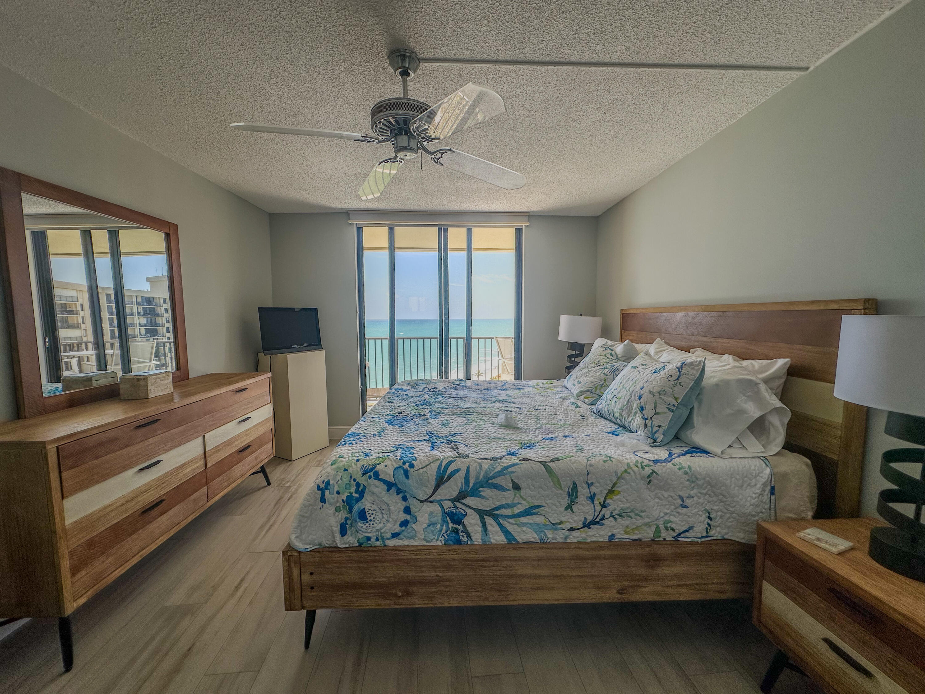 200 Ocean Trail Way, Unit 1107 Jupiter, FL 33477 - Photo 21 of 29 a bedroom with a bed and wooden floor