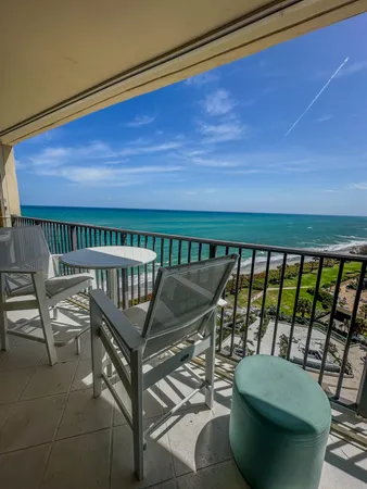 a view of a chairs and table in the balcony