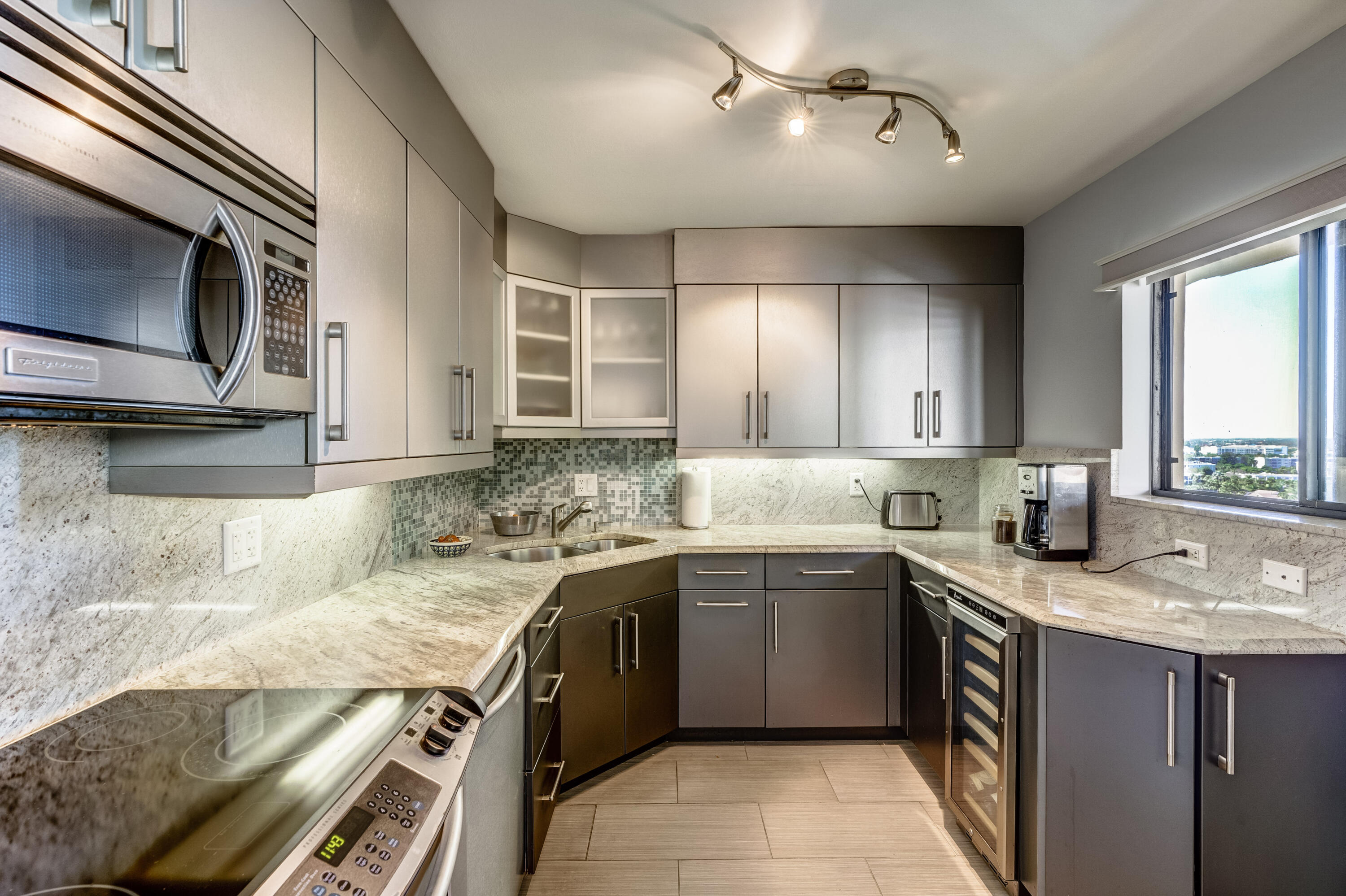 200 Ocean Trail Way, Unit 1107 Jupiter, FL 33477 - Photo 8 of 29 a kitchen with a sink stove and microwave