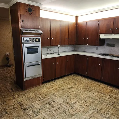 a kitchen with stainless steel appliances granite countertop a sink stove and cabinets