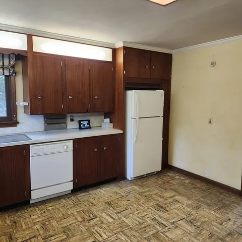 a kitchen with a refrigerator sink and cabinets