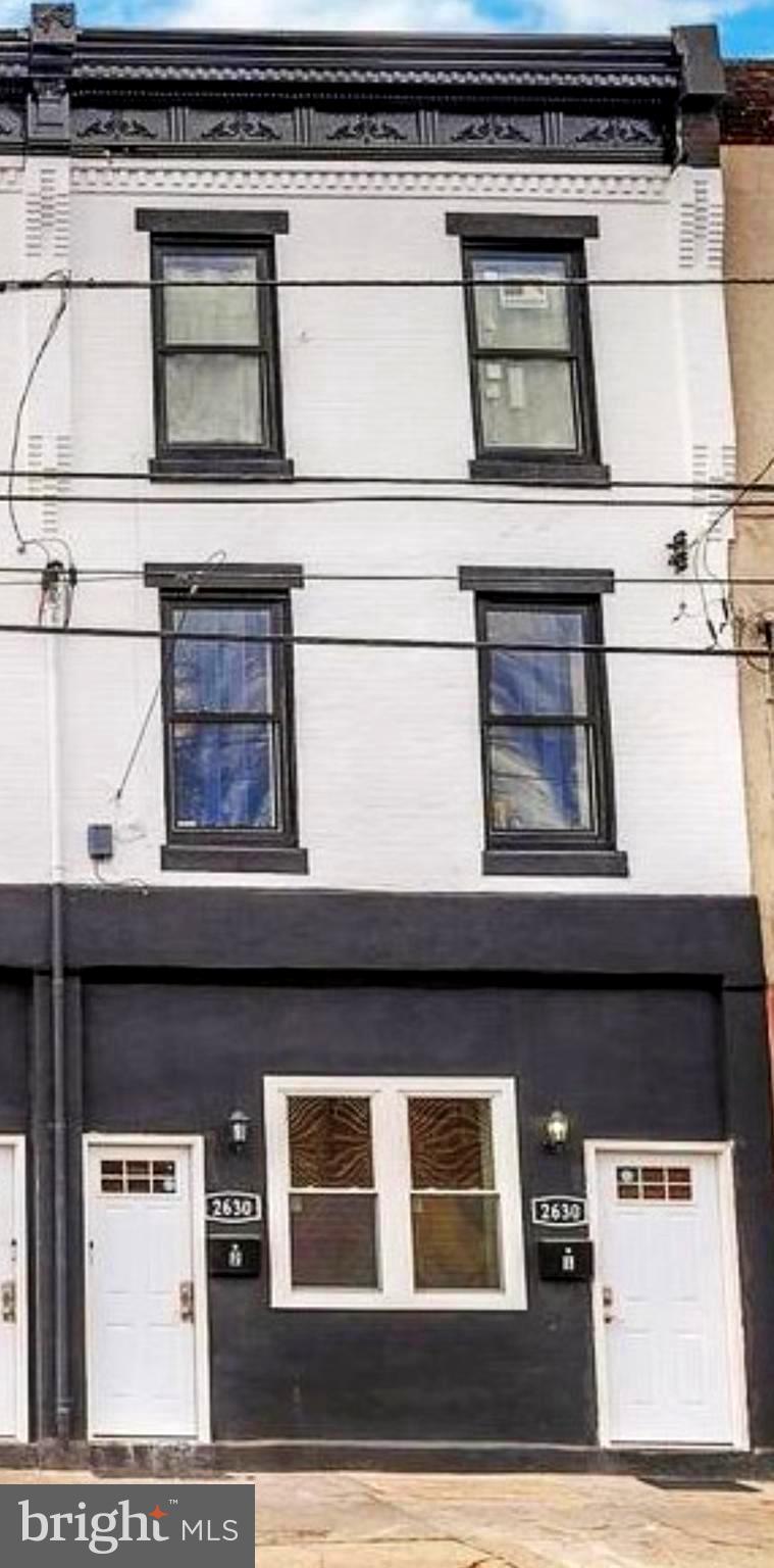a black and white building with black door