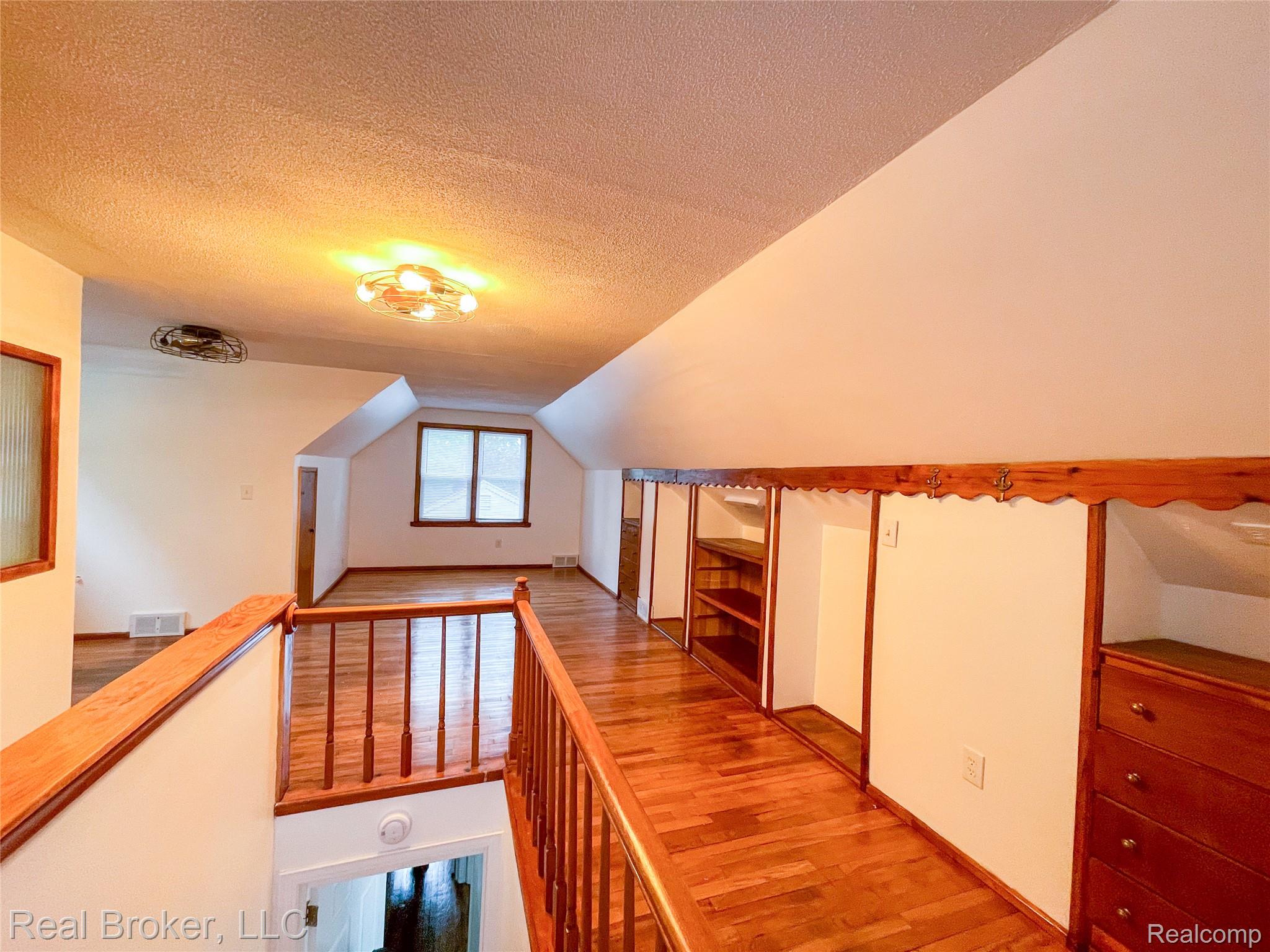 603 Vernier Road Grosse Pointe, MI 48236 - Photo 13 of 33 Corridor with wood finished floors and an upstairs landing