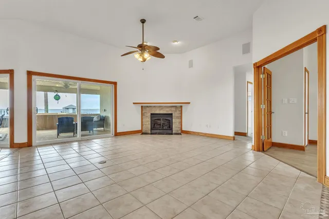 a view of a workspace with a bookshelf and a potted plant
