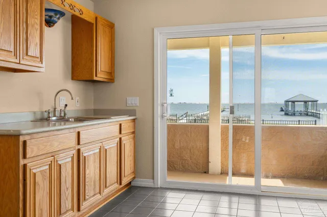 a view of a room with a chandelier and glass door