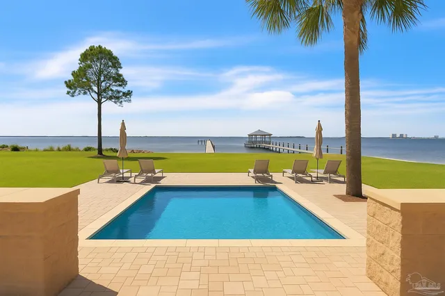 a view of a swimming pool and an outdoor seating