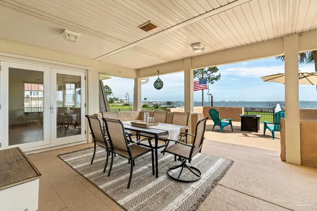 a dining room with furniture and a floor to ceiling window