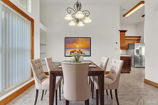 a view of a dining room with furniture and chandelier