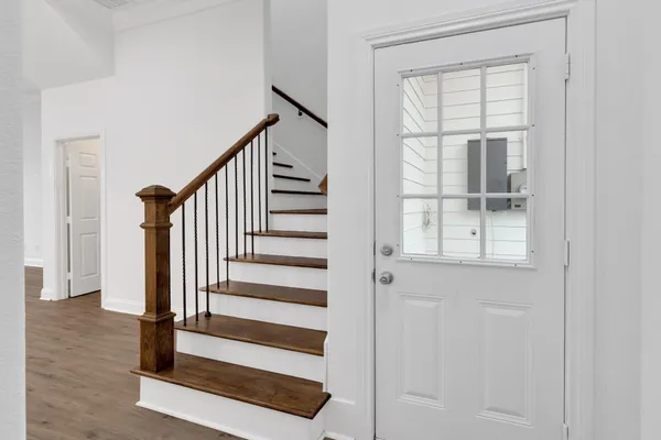 a view of entryway with wooden floor and stairs