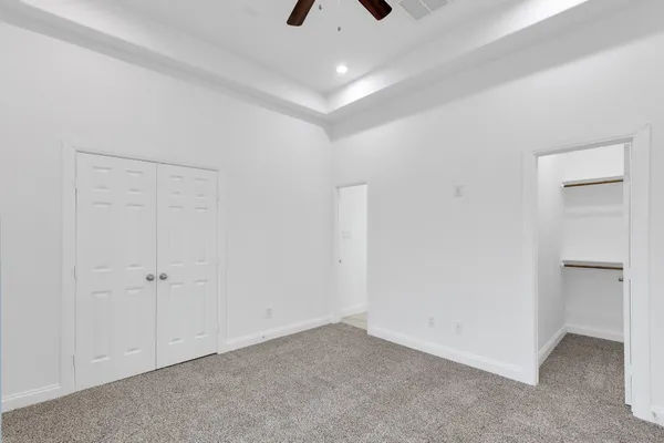an empty room with a ceiling fan and a ceiling fan