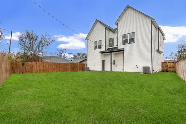 a view of a backyard with plants and a big yard