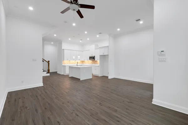a view of a kitchen with a sink and wooden floor