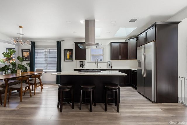 a kitchen with stainless steel appliances granite countertop a refrigerator and a table