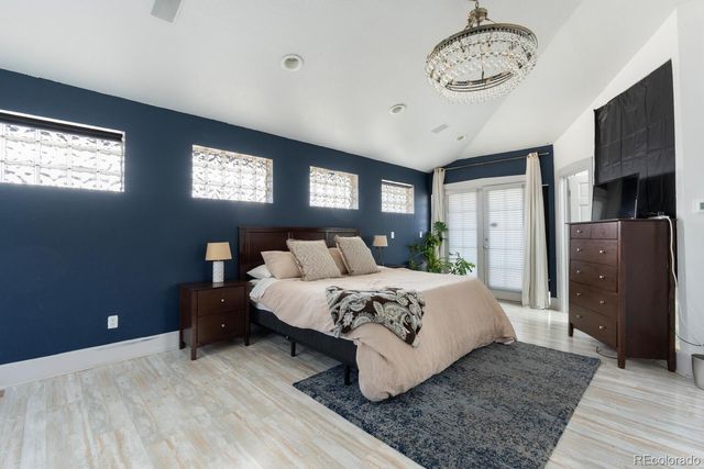 a bed room with a bed and a chandelier