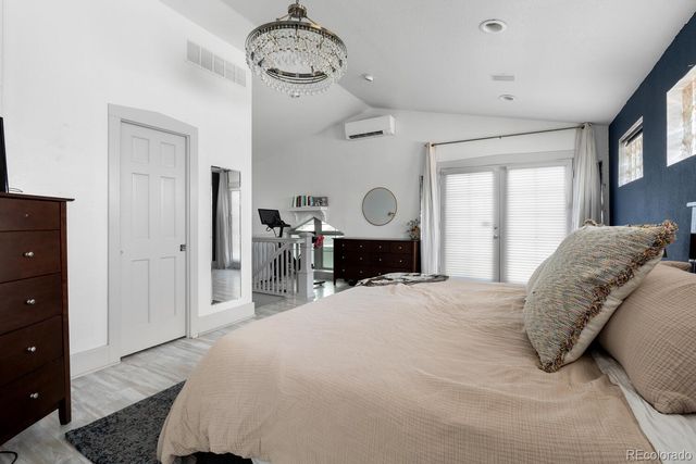 a bed room with a bed and a chandelier