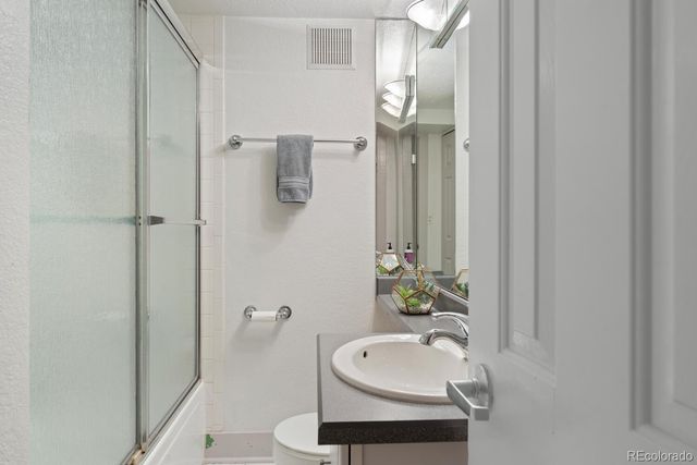 a bathroom with a double vanity sink and mirror with shower