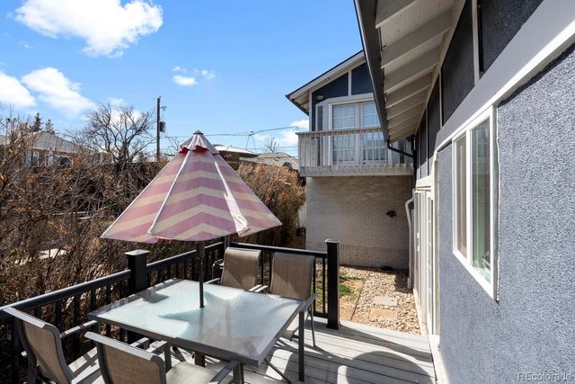 a backyard of a house with table and chairs