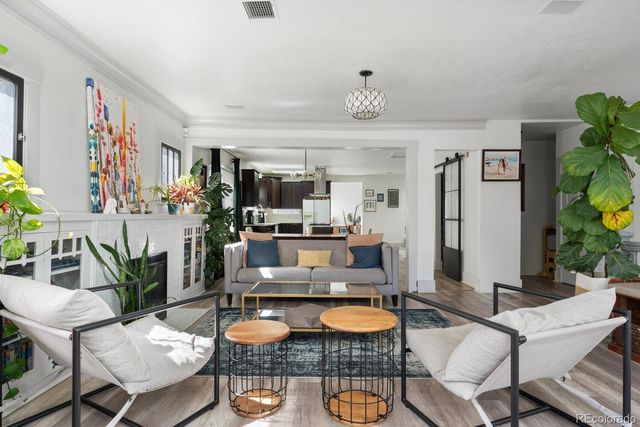 a living room with furniture and a dining table