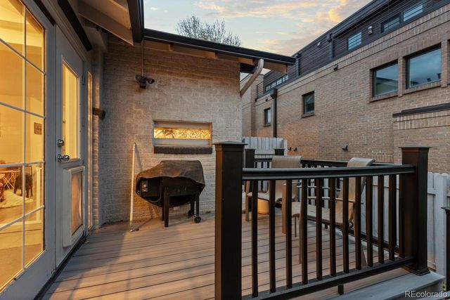 a view of a balcony with furniture and wooden floor