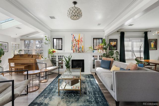 a living room with furniture large window and a fireplace