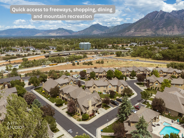 6761 950 East Midvale, UT 84047 - Photo 36 of 44 Aerial perspective of a residential community featuring multiple multi-story townhomes with pitched roofs