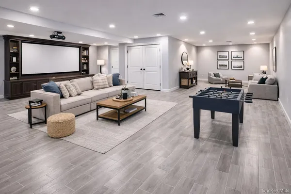 a living room with furniture a wooden floor and a flat screen tv
