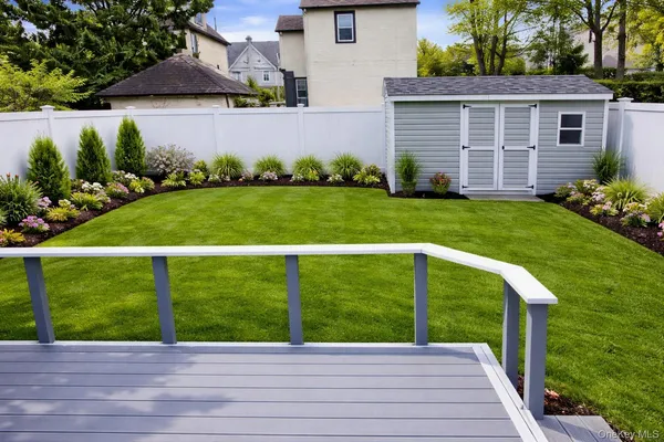 a view of a backyard with brick wall