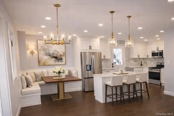 a dining room with furniture a large window and kitchen view