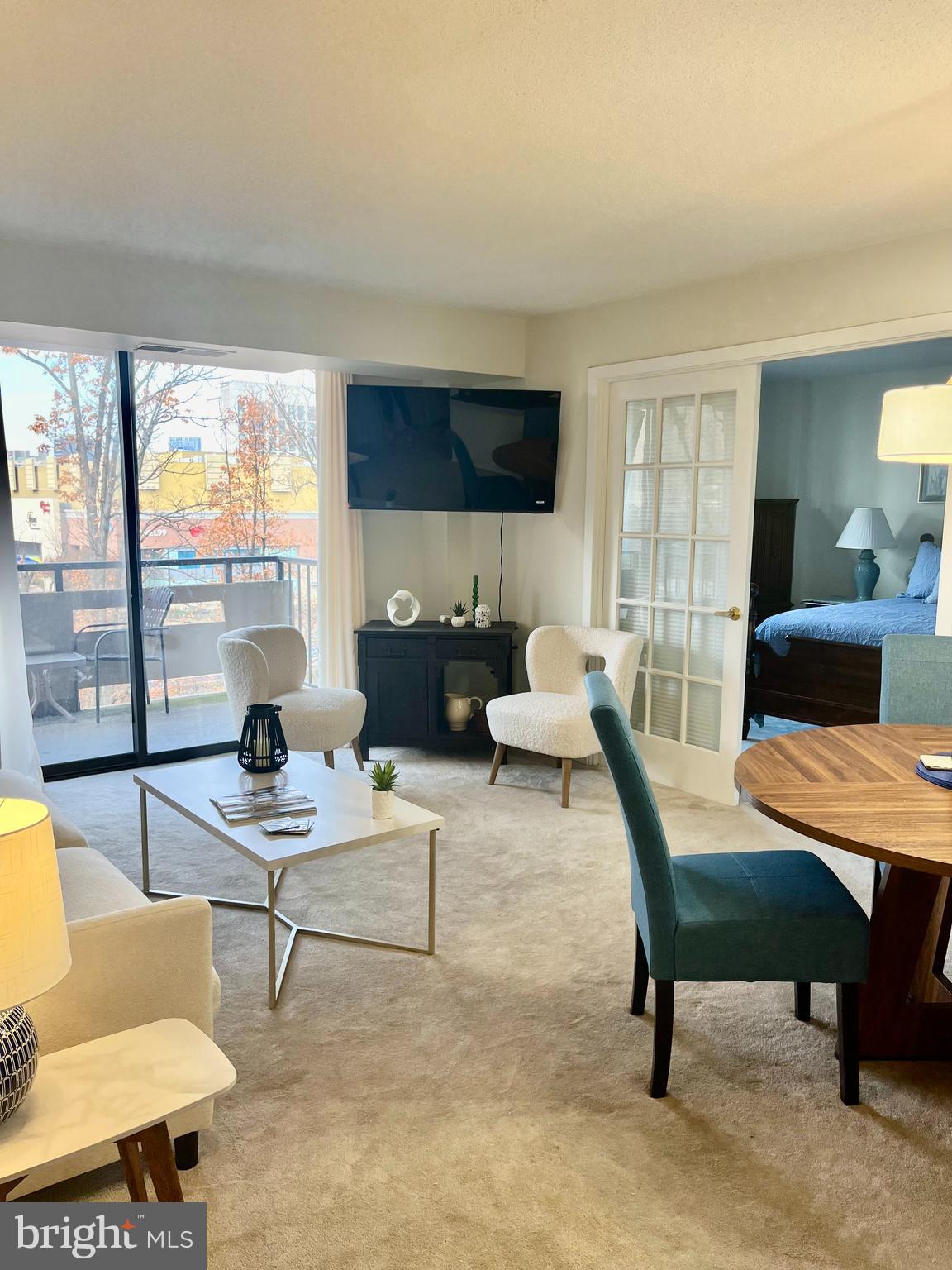 1808 Old Meadow Road, Unit 1104 McLean, VA 22102 - Photo 13 of 35 a living room with furniture and a large window