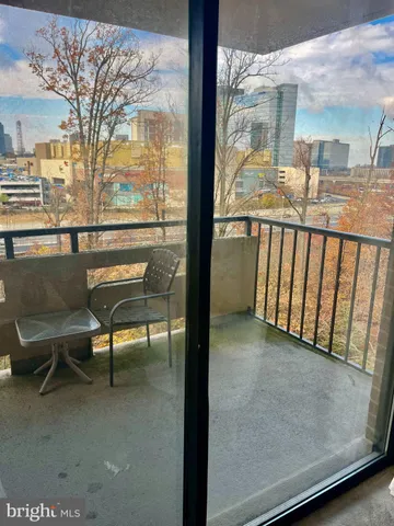 a view of a porch with furniture and a yard