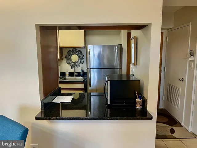 a living room with chairs and a table