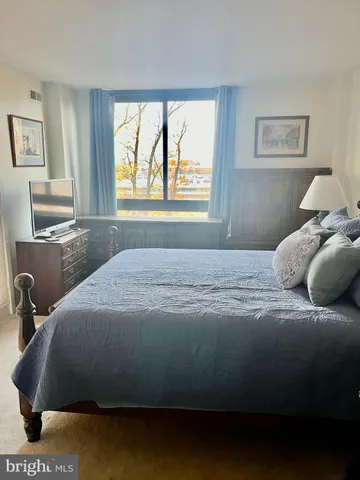 a bedroom with a bed and window