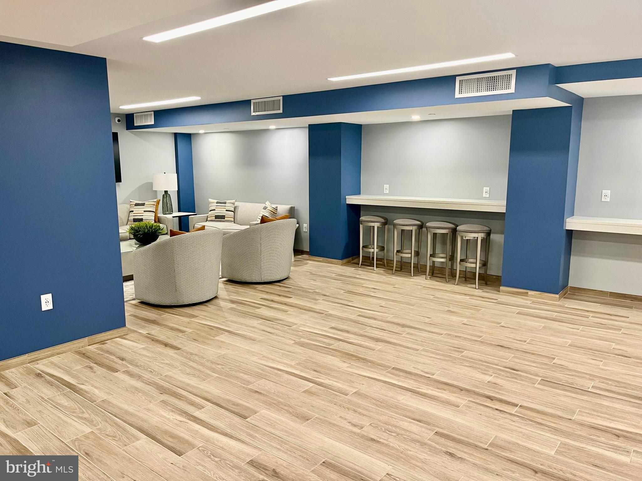 1808 Old Meadow Road, Unit 1104 McLean, VA 22102 - Photo 34 of 35 a living room with a couch and a flat screen tv