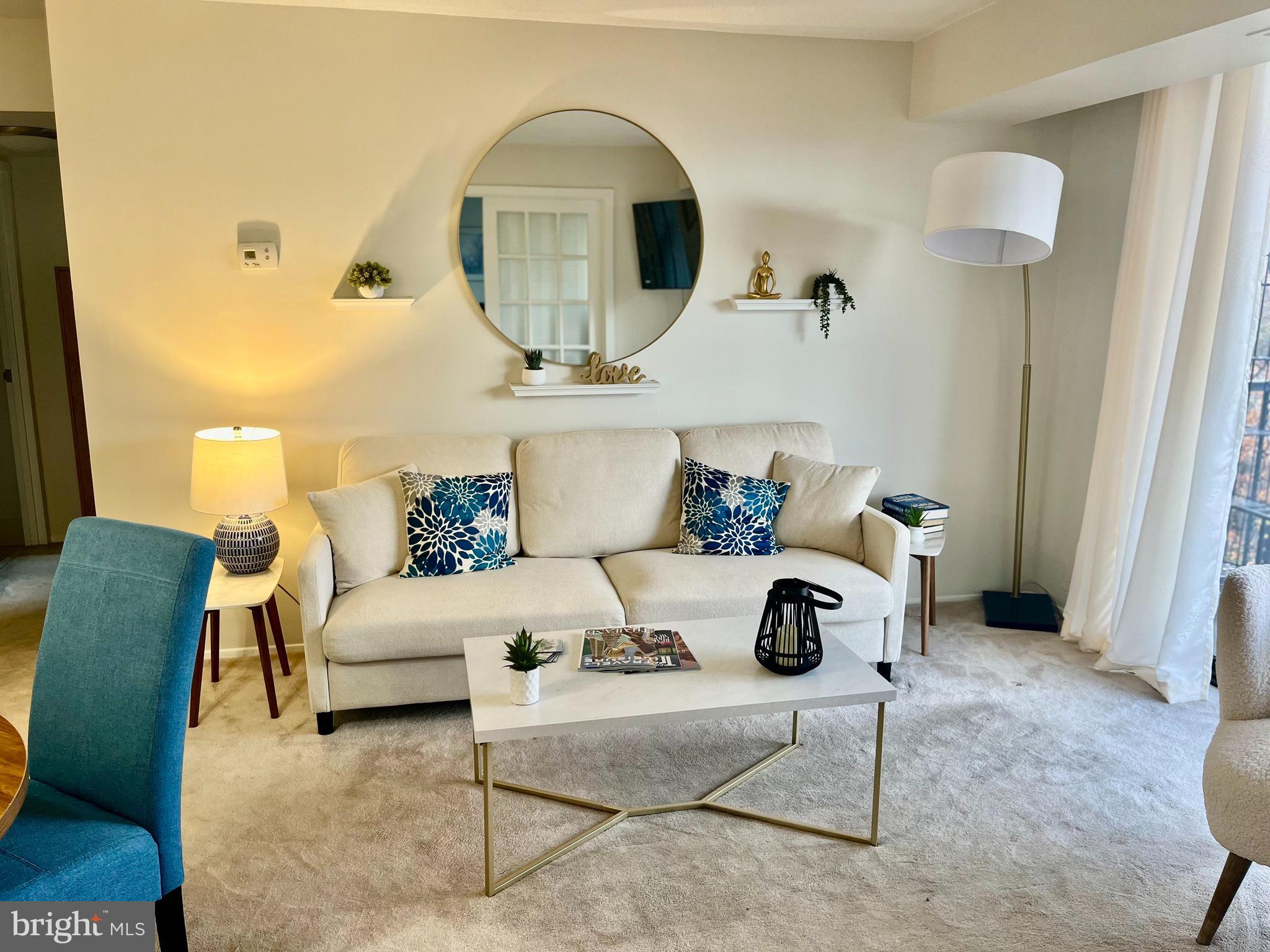 1808 Old Meadow Road, Unit 1104 McLean, VA 22102 - Photo 10 of 35 a living room with furniture a rug and white walls