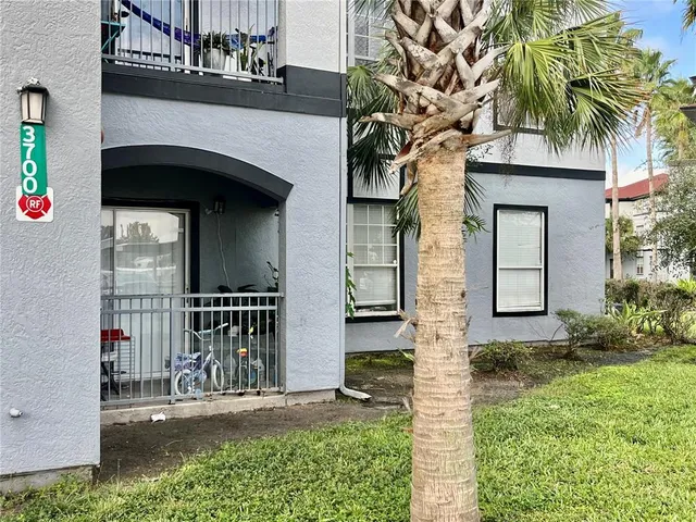a front view of a house with plants