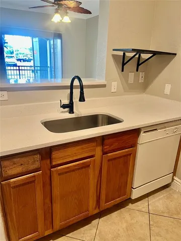 a kitchen with a sink and a mirror