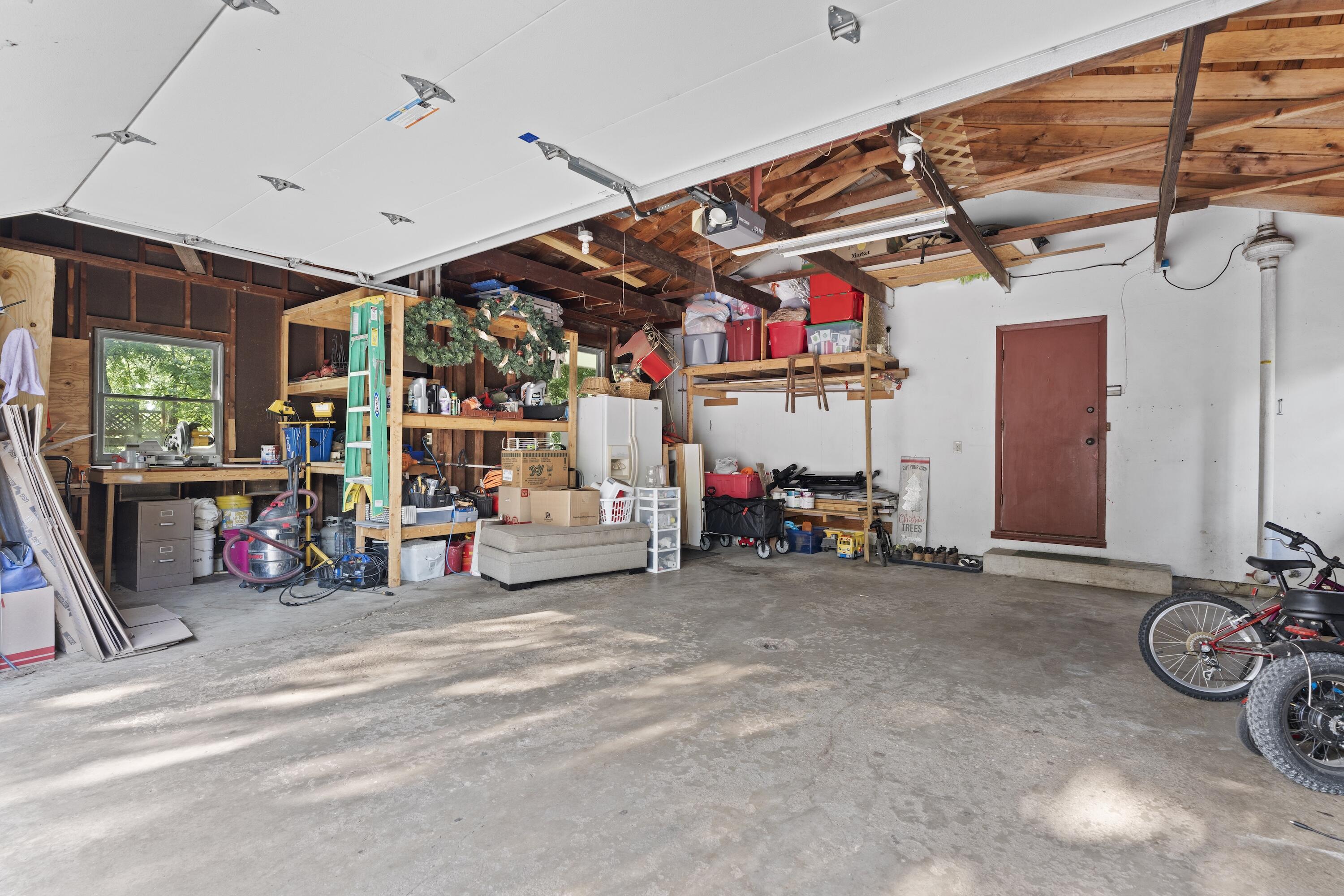 N8093 Lakeview Road Oconomowoc, WI 53066 - Photo 37 of 44 Spacious 2.5 car attached garage with storage shelving and dedicated workshop area.