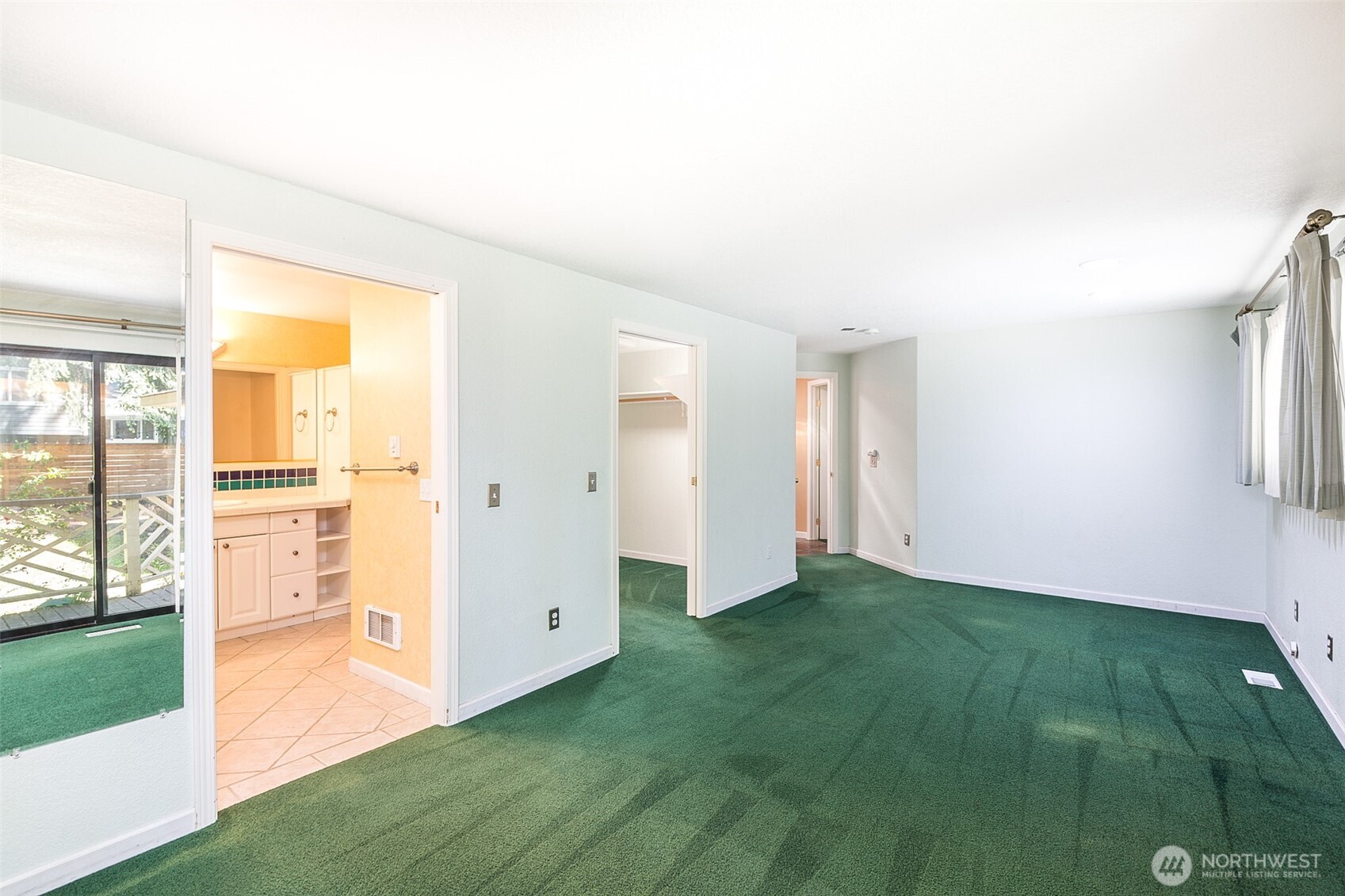 123 Forest Ridge Drive Sequim, WA 98382 - Photo 23 of 32 a view of an empty room with window and a kitchen