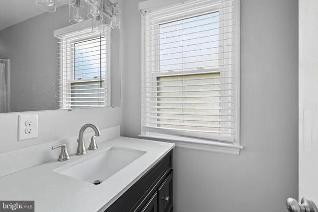 a bathroom with a sink and a window