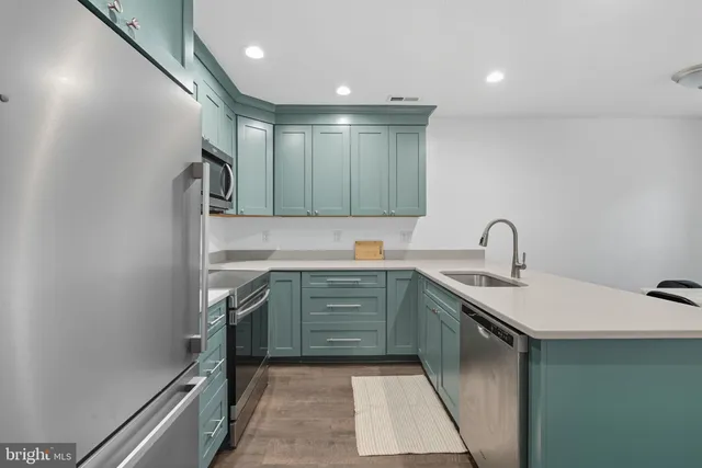 a kitchen with sink a stove and cabinets