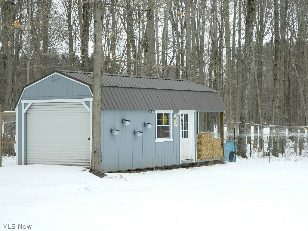 12464 Hotchkiss Road Burton, OH 44021 - Photo 31 of 35 12x28' Outbuilding with Full Garage Door and Service Door. Current Owner Has Chickens - Even the Chickens have a Wonderful Home!