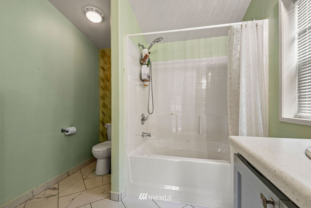 878 Oak Point Road Longview, WA 98632 - Photo 11 of 32 a bathroom with a granite countertop sink toilet and shower