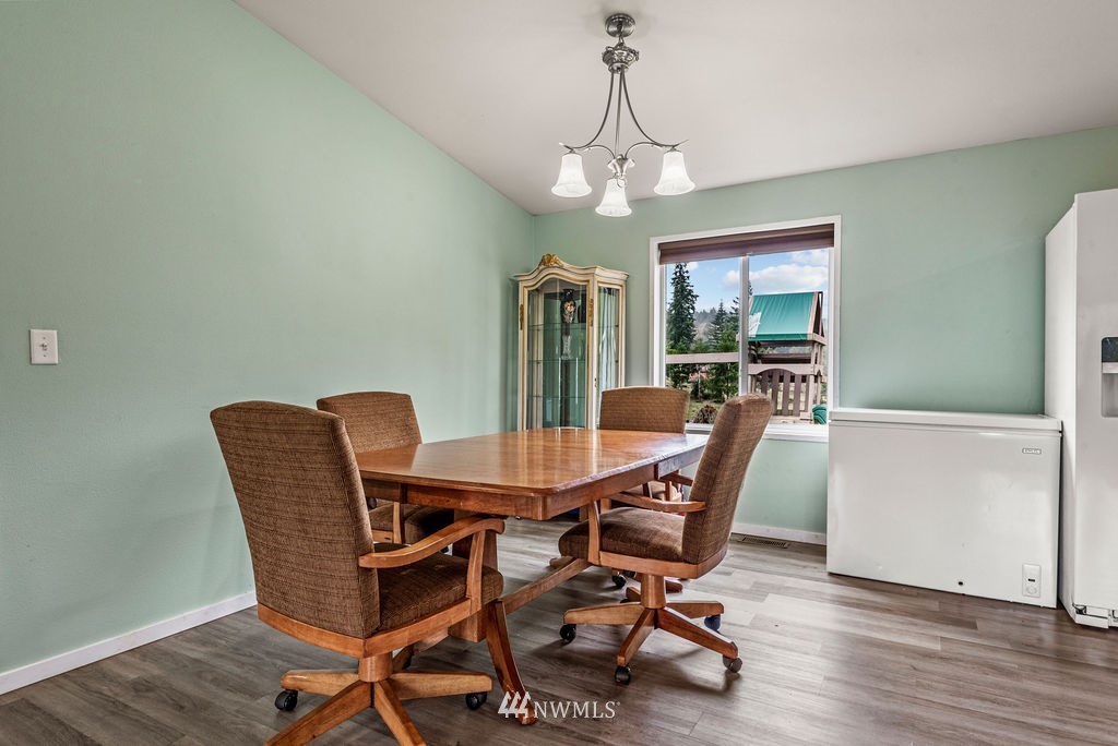 878 Oak Point Road Longview, WA 98632 - Photo 14 of 32 a view of a dining room with furniture window and wooden floor