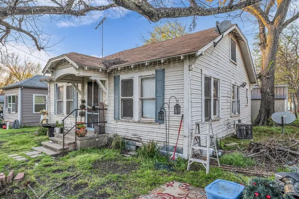 a view of a house with a chairs in a patio
