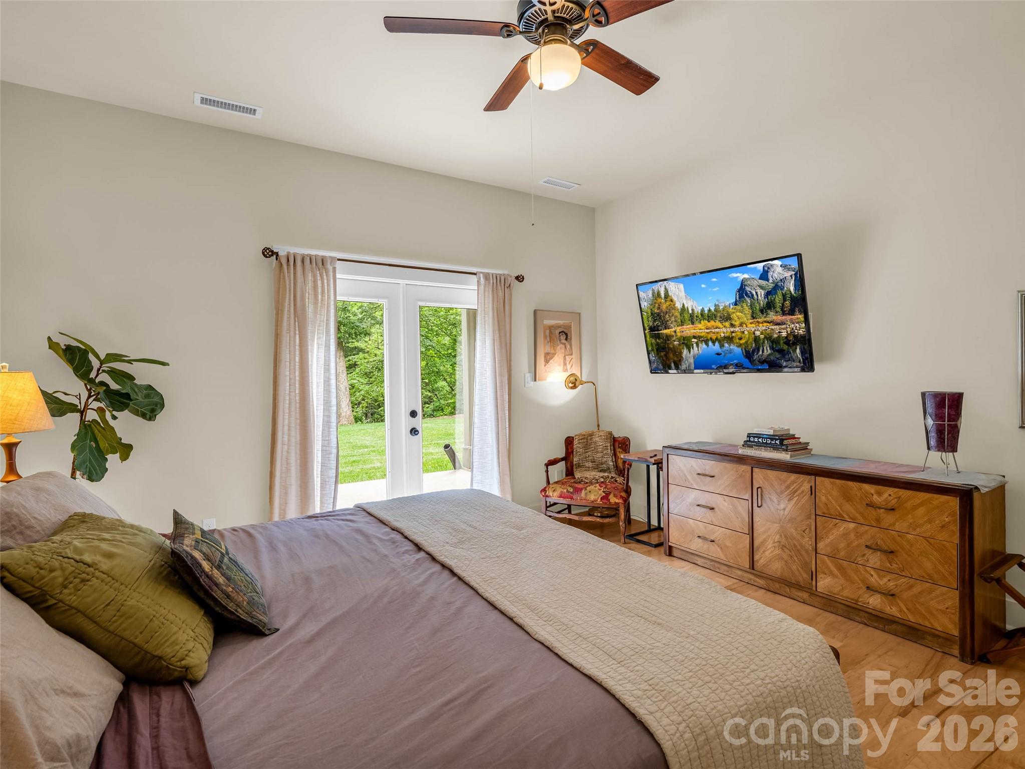 120 Glenn Court Mill Spring, NC 28756 - Photo 40 of 48 a bedroom with a bed and a chandelier