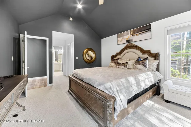 a bedroom with a bed and painting on the wall