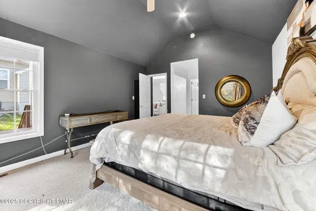 a bed sitting in a bedroom next to a window